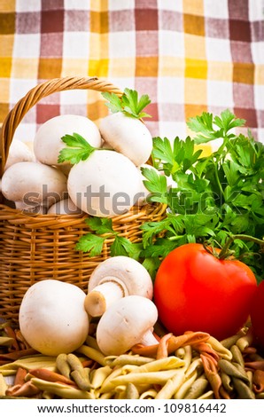 Wicker basket full of fresh champignon mushrooms