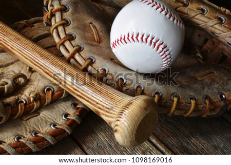 A close up image of old used baseball equipment. 