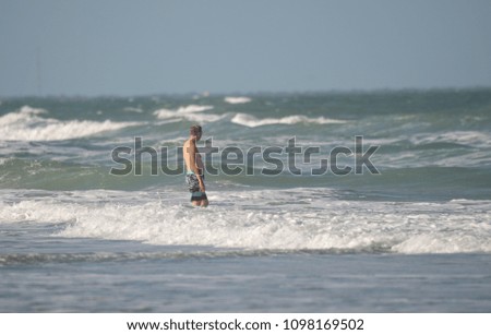 unknown man is watching the power of the ocean