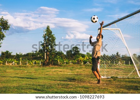 An action sport picture of a group of kid playing soccer football for exercise. Picture with copy space.