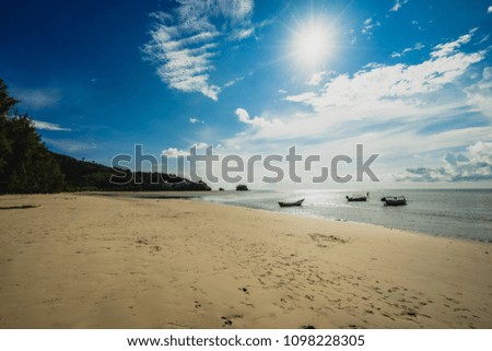 Sun of summer time Long tail boats and sky and sand of beach, Naiyang beach, Phuket, Thailand. 