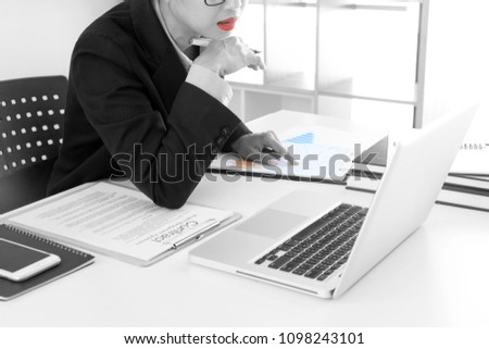 businesswoman leader of the group in business teamwork concept woman leadership ,woman make up red lip , black and white with color on paper graph chart.