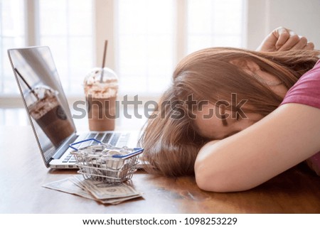 The girl exhausted after shopping online with laptop.