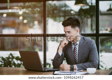 Business man working at office with laptop and documents on his desk, consultant lawyer concept