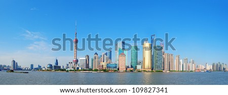Shanghai skyline panorama with skyscrapers and blue clear sky over Huangpu River.