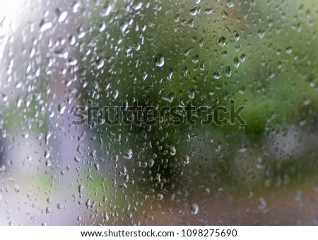 Drops of water on the glass. Blurred background. Focus on the center