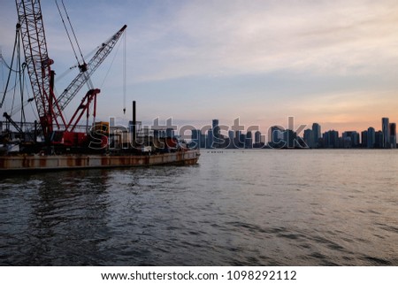 New York City skyline with urban skyscrapers over Hudson River. Manhattan panorama from Chelsea district. Pier waterfront view to the harbor at sunset.

