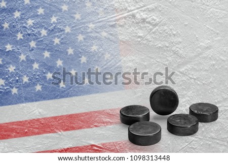 Hockey pucks and the image of the American flag on the ice. Concept, hockey, background