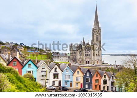 Cathedral  and colored houses in Cobh, Ireland Royalty-Free Stock Photo #1098315935