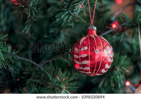 Christmas tree globe ornament. Baubles on fir tree branches.