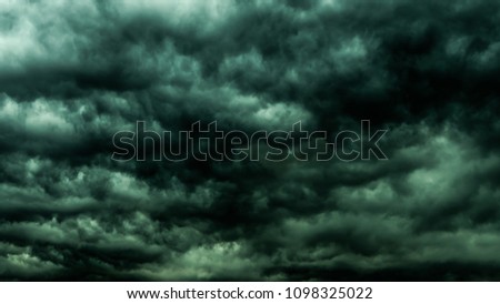 Dramatic dark sky and clouds. Cloudy sky background. Black sky before thunder storm and rain. Background for death,  sad, grieving or depression. 