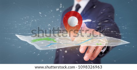 View of a Businessman holding a 3d rendering pin holder on a map