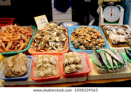 Fresh seafoods such as fishes,
crabs,prawns and octopus on display at famous Dongmun Traditional Market in Jeju Island,South Korea. The food label shows kind of crab and price tag .
 Royalty-Free Stock Photo #1098339563