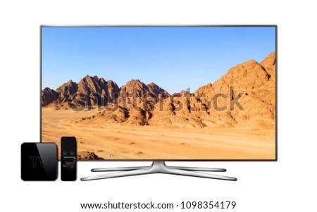 Smart tv and multimedia box with remote controller and mountain landscape wallpaper on screen