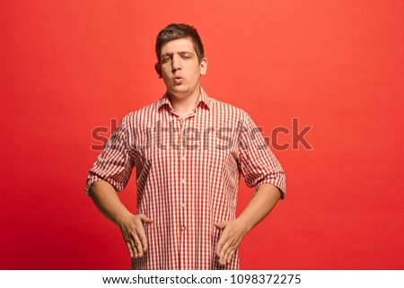 Argue, arguing concept. Funny male half-length portrait isolated on red studio backgroud. Young emotional surprised man looking at camera. Human emotions, facial expression concept. Front view