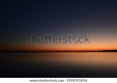 Twilight sky over the lake in the beautiful colors of the sunset afterglow