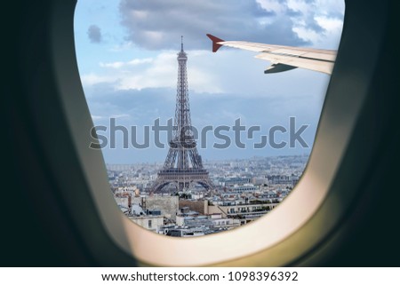 Aerial view Paris cityscape through airplane window while approaching to airport 