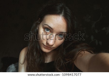 pretty girl doing a self-portrait indoors