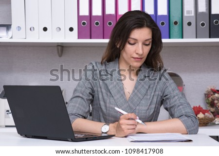 I am listening really carefully. Portrait of a beautiful female manager in the office with a laptop with a visitor. She is right in front of the camera smiling and looks attentive