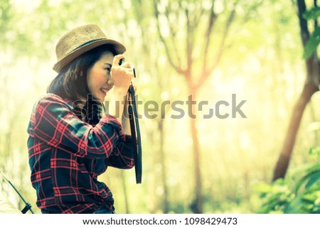 asian woman take photo in forest camp travel concept