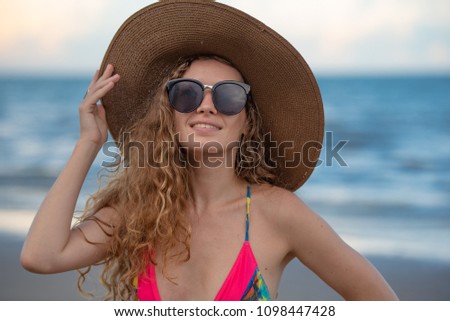 Portrait happy woman with long blonde curly hair on the beach with enjoying, hairstyles for dresses concept.