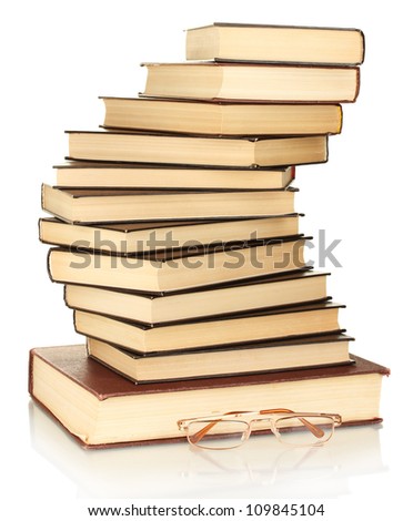 tower of books with glasses isolated on white background