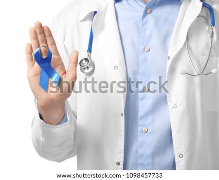 Doctor holding blue ribbon on white background, closeup. Prostate cancer concept