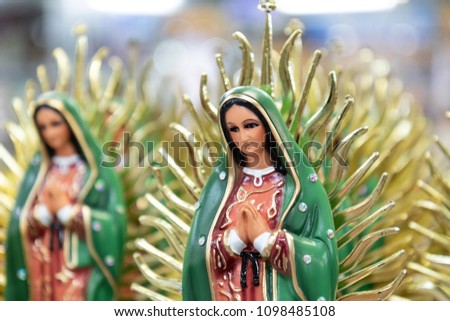 Figurine of the Virgin of Guadalupe sold on nearby stalls Royalty-Free Stock Photo #1098485108