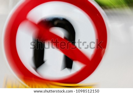 Abstract motion blur effect. Red and black no u-turn symbol
