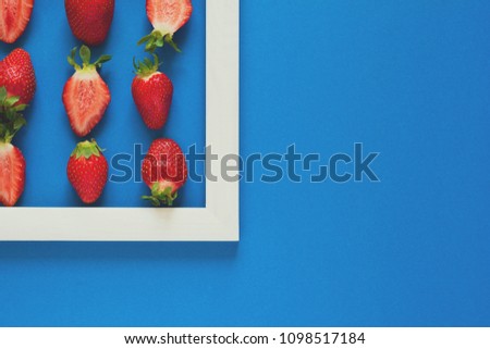 Minimalism. Strawberry martix. Masterpiece in wooden frame. Top view. Flat lay. Toned
