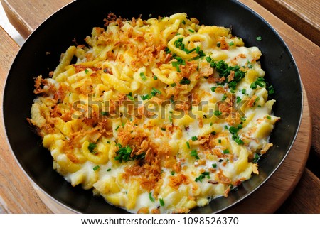 Käsespätzle - Traditional Tirolean noodles with cheese and onion Royalty-Free Stock Photo #1098526370