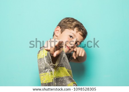 Boy with his fingers pointed at the camera. Child with positive expression Royalty-Free Stock Photo #1098528305