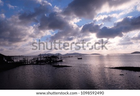 Fisherman's boat and village in silhouette picture