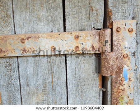 old rusty hinge on wooden door