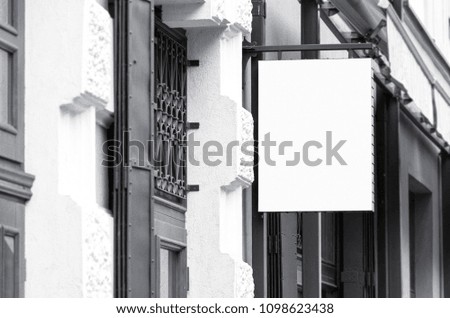 Blank square outdoor commercial signage mockup, black and white real architecture picture 