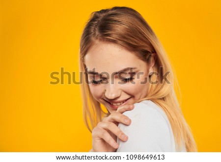 Happy blonde on a yellow background                          