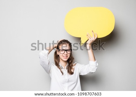Business woman holding a speech bubble on gray