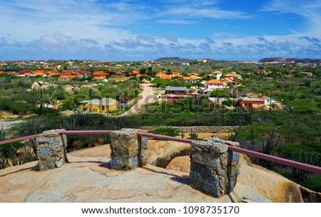 Aruba Caribbean Island Overlook inland. Bathed in the warmth of a turquoise sea and cooled by trade winds, Aruba is the happy home to constant sunshine and powdery-soft white-sand beaches.