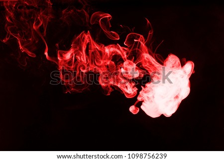 Red smoke on black background.
