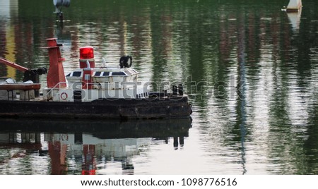 Miniature toy boat with siren in river