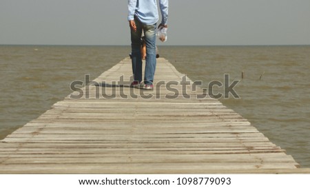 Man Walking on Wooden Dock Toward the Sea - Muddy Rough Water - Phetchaburi, Thailand