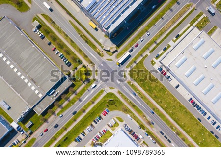 Aerial view of junction in industrial zone and technology park. City infrastructure and traffic from above.
