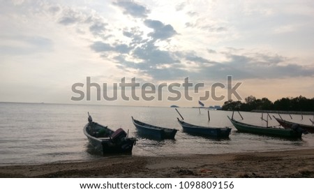 sea view with a few fisherman boat landing at the beach. view sunset show the picture full dramatics 