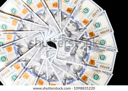 One hundred dollars bills isolated on black background