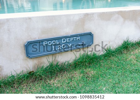 warning pool depth sign by swimming pool in modern resort for safety