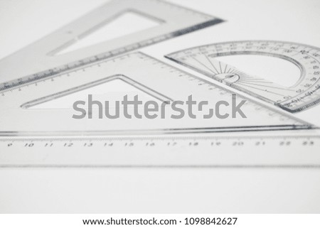 Set of multiple plastic rulers and the protractor, isolated over the white background