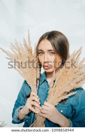 young lady dressed in jeans jacket standing isolated over white background