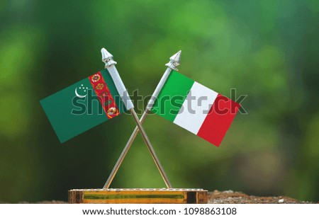 Italy and Turkmenistan flag with blur green background