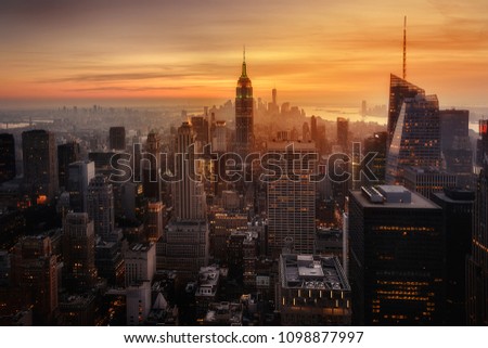 View of New York City from the top of one of its viewpoints, capturing the warm light of sunset