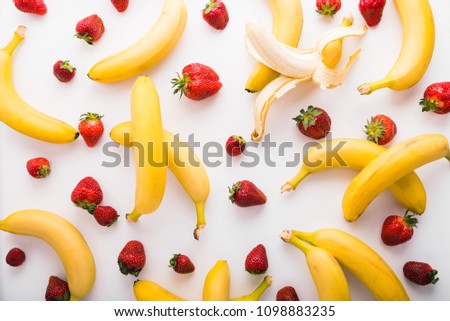 Bananas and strawberries pattern, top view Royalty-Free Stock Photo #1098883235